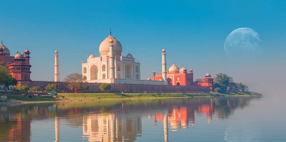 Taj Mahal reflection in Yamuna River under a clear blue sky